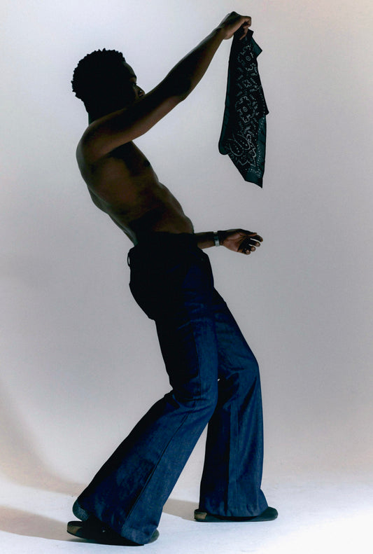 Man wearing blue denim flare pants with vintage bell bottom silhouette