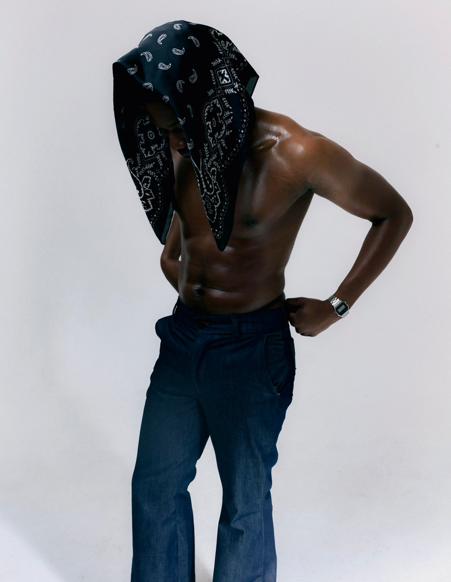 Man wearing blue denim flare pants with vintage bell bottom silhouette
