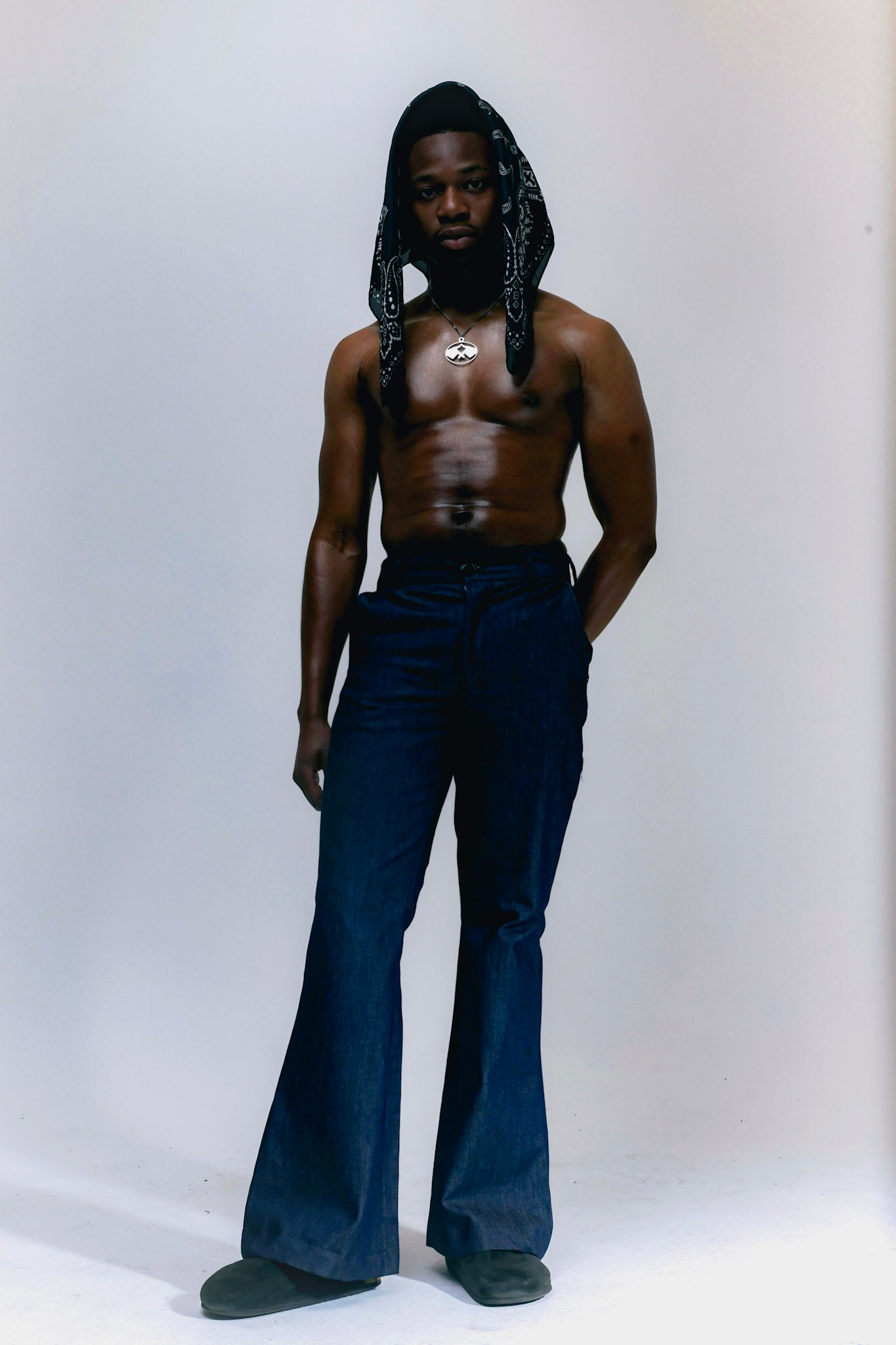 Man wearing blue denim flare pants with vintage bell bottom silhouette