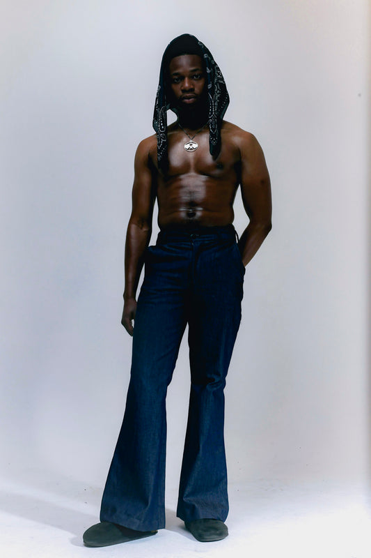 Man wearing blue denim flare pants with vintage bell bottom silhouette