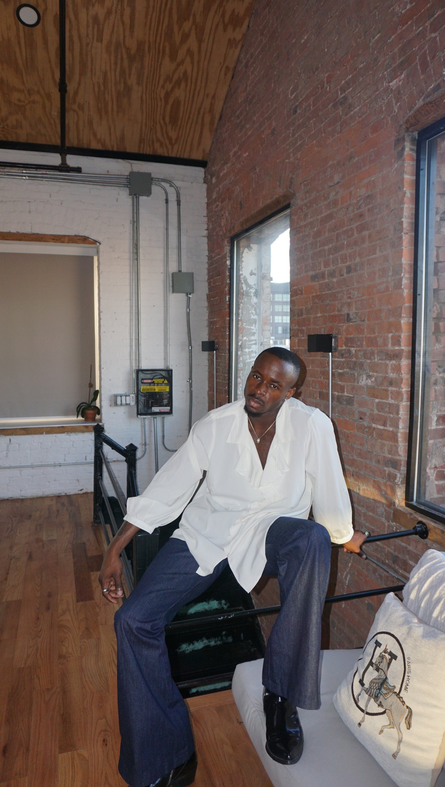 Man wearing blue denim flare pants with vintage bell bottom silhouette