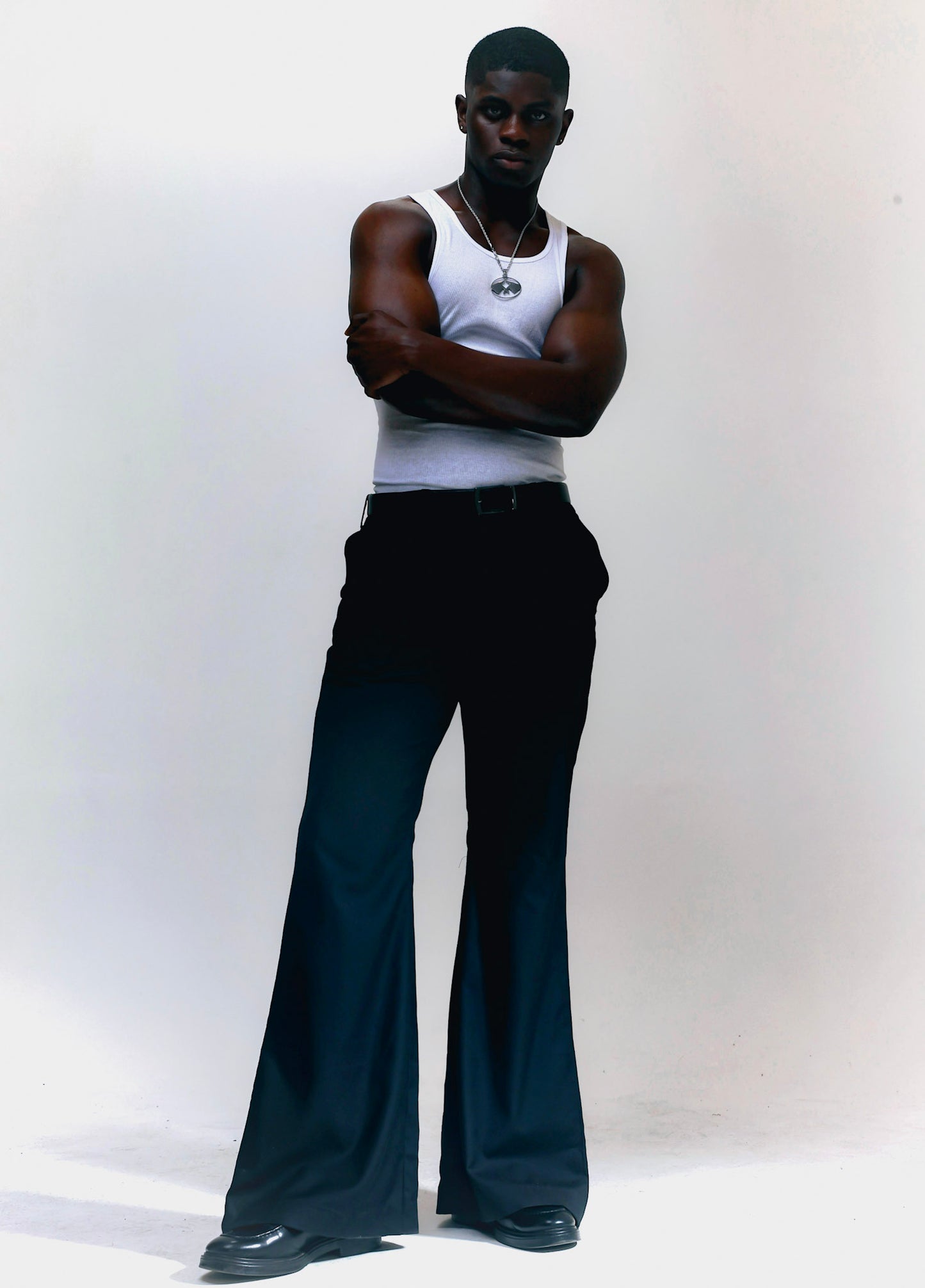 Men wearing black flare pants with vintage 70s bell bottom silhouette