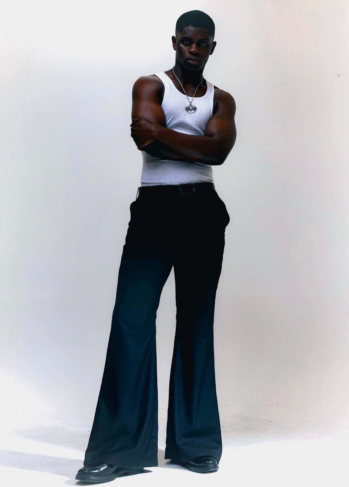 Men wearing black flare pants with vintage 70s bell bottom silhouette