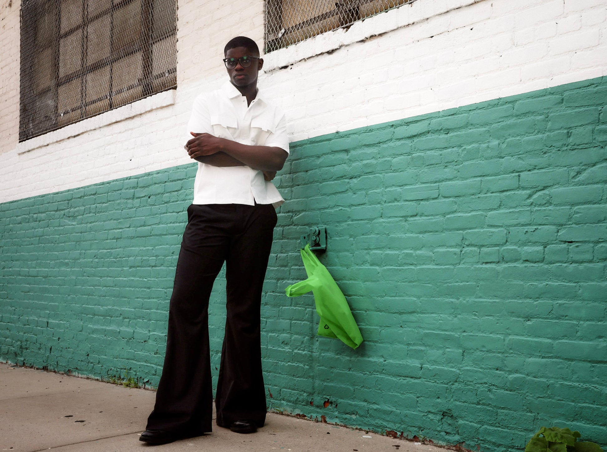 Men wearing black flare pants with vintage 70s bell bottom silhouette