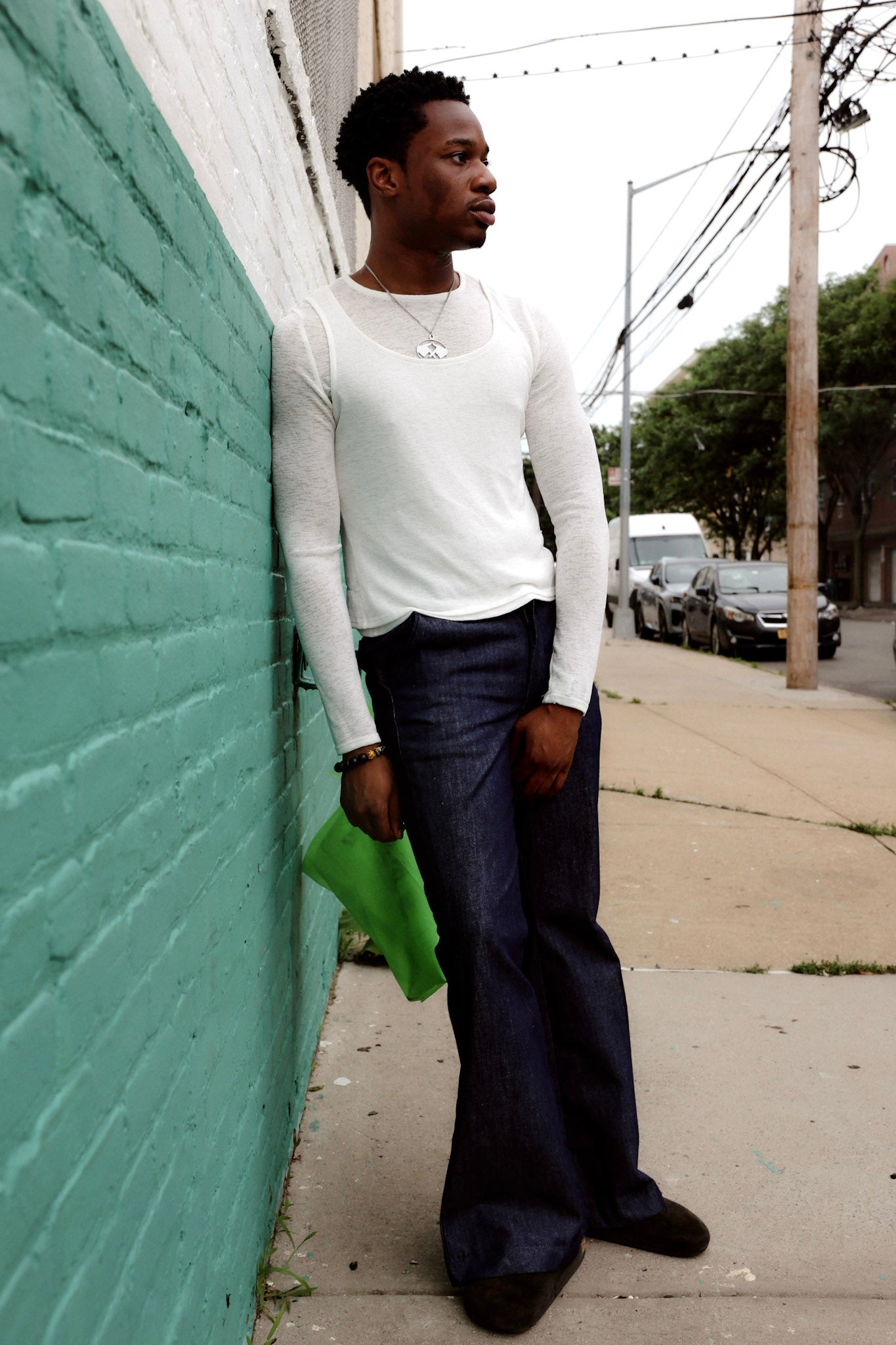 Man wearing blue denim flare pants with vintage bell bottom silhouette